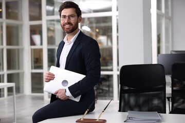 Wall Mural - Portrait of smiling man with laptop in office, space for text. Lawyer, businessman, accountant or manager