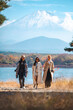 © chokniti - Happy tourist traveler woman or man enjoying on lake kawaguchiko with mount fuji in japan, spring and summer, Japan travel vacation site