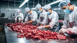 © Nittaya - group of worker in meat factory, chopped a fresh beef meat in pieces on metal work table, industry of processing food.