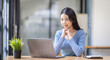© David - Asian Business woman using calculator and laptop for doing math finance on an office desk, tax, report, accounting, statistics, and analytical research concept