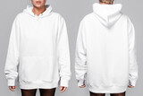 Fototapeta  - Front and back views of a woman wearing a white, oversized hoodie with blank space, ideal for a mockup, set against gray background