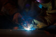 © DG PhotoStock - Heavy industry duty worker using a welding torch welds an iron steel in factory.