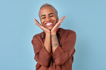 Wall Mural - Young cute delighted African American woman laughing and resting chin on hands feeling euphoria and good mood after receiving date invitation from boyfriend stands on turquoise background.