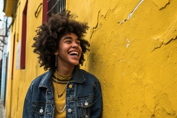 Wall Mural - a woman smiling in front of a yellow wall