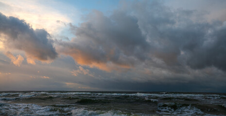 Wall Mural - panorama of storm clouds over the sea during sunset