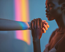 Interracial Love: Two Skin Tones, N Beautiful African American Female And A Fair Skin Human, Holding Hands In A Dramatic Stylish Photo Featuring Natural Sunlight And Rainbows
