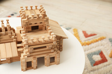 Sticker - Wooden castle on white table indoors, space for text. Children's toy