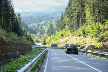 Wall Mural - Picturesque view of asphalt road with modern car