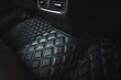 Premium luxury leather floor mat in a modern car interior. Auto service industry. Second row interior of a premium car with floor car mat. The modern, sophisticated and luxurious interior design.