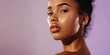 © IndigoElf - Portrait of young African woman with clean healthy facial skin on flat purple background with copy space. Natural beauty, care cosmetics banner template, perfect face skin.