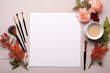 Graphic resources, hobbies and leisure concept. Top view of blank white paper sheet with copy space surrounded with flowers, brushes and paints
