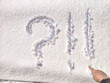 A question mark written on snow with sequins or confetti. The concept of Uncertainty of choice, expectations, and decisions. Fate in the New Year