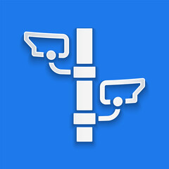 Poster - Paper cut Security camera icon isolated on blue background. Paper art style. Vector