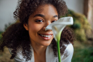 Wall Mural - Beautiful afro girl in a white shirt relaxing in the park.