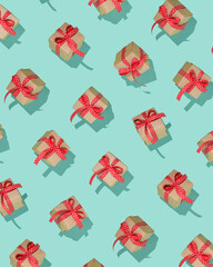 Wall Mural - Seamless pattern with craft gift boxes with red bows on turquoise background