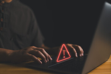 Poster - User is using computer with triangle caution warning sign for notification error and maintenance concept. Hacker attacks and hacking data, cyber crime, Ransomware, Phishing, Spyware, cybersecurity..