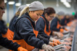 Asian female seafood processing plant workers work on an assembly line