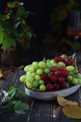 Poster - A bowl with red and green grape in rustic style