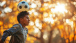 Hispanic teen balancing soccer ball on his head