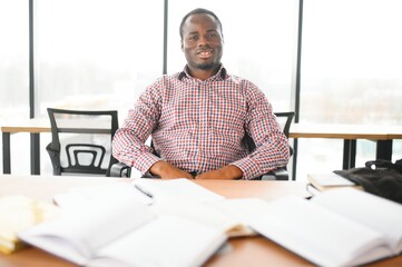 Wall Mural - Male student sitting in university classroom. Man sitting in lecture in high school classroom.