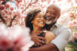 © MNStudio - Happy senior black couple walking a blossoming sakura park on spring evening. Retired husband and wife having fun outdoors. Retirement hobby and leisure activity for elderly people.