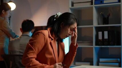 Wall Mural - The businesswoman is using a white calculator to check company financial information, she is checking company financial information from the documents provided by the finance department.