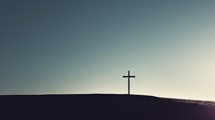  a cross on top of a hill with the sun shining through the sky in the back ground of the hill.