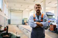 Portrait Of Truck Repair Shop Owner With Arms Crossed Looking At Camera.