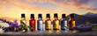 different aromatic oils in bottles on the background of water