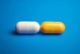 Fototapeta  - Two different pills over the yellow and blue background
