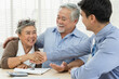 Happy smiling Asian retired senior couple making purchase and mature woman handshake with real estate agent, Sales man closing deal from business agreement contract, Healthy living and insurance