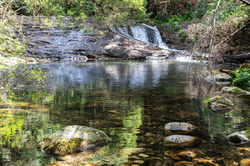 Wall Mural - Pincho Waterfall near Viana do Castelo, Northern Portugal. View of the flowing water and beautiful lagoon, in the woods