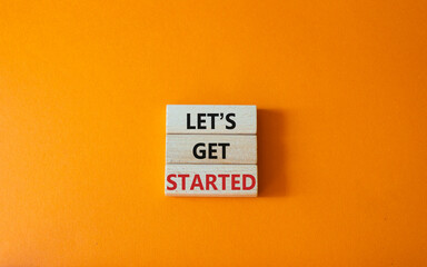 lets get started symbol. concept words lets get started on wooden blocks. beautiful orange backgroun