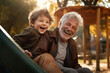 Happy grandfather and child have fun and play in park 