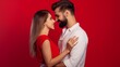 © Lumos Maxima - Side view of caucasian, attractive, smiling couple - bearded man embrace his charming, cute, pretty woman, looking to each other while standing over red background, 14 February