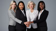 © MP Studio - Group of five women in professional attire, smiling and standing close together, with their hands joined in a sign of unity and support