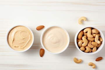 Bowls of hazelnut, cashew and almonds butter on wooden background