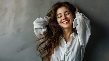 Wall Mural - Beauty fashion portrait of smiling sensual young woman with dark long hair in white shirt and jeans on gray background banner, relaxed and chilled, copy space.