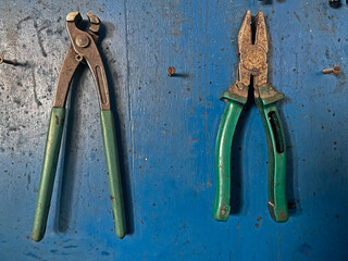 Pliers hanging on the workbench at the mechanic's.