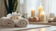 Horizontal illustration for advertising aroma and SPA treatments: massage table with white towels, orchids and scented candles on the background.