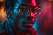 © Gonzalo - African American man portrait in sunglasses, isolated on neon background