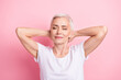 © deagreez - Portrait of relaxed person with white hairdo dressed stylish t-shirt hold hands behind head eyes closed isolated on pink background