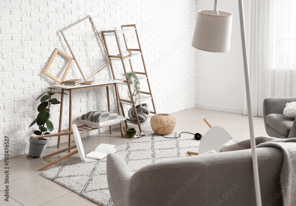 Tables with shelving unit in messy living room