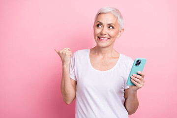 Canvas Print - Photo of pensioner woman empty space instagram twitter facebook telegram dressed stylish white clothes isolated on pink color background