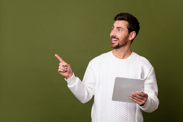 Poster - Photo of glad stylish man looking empty space showing offer proposition isolated on khaki color background