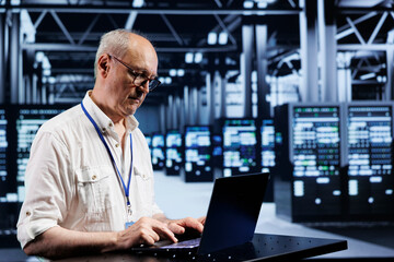 Poster - Experienced serviceman using laptop, setting up high bandwidth dedicated multiplayer gaming servers in high tech establishment to accommodate more traffic from worldwide locations and avoid low ping