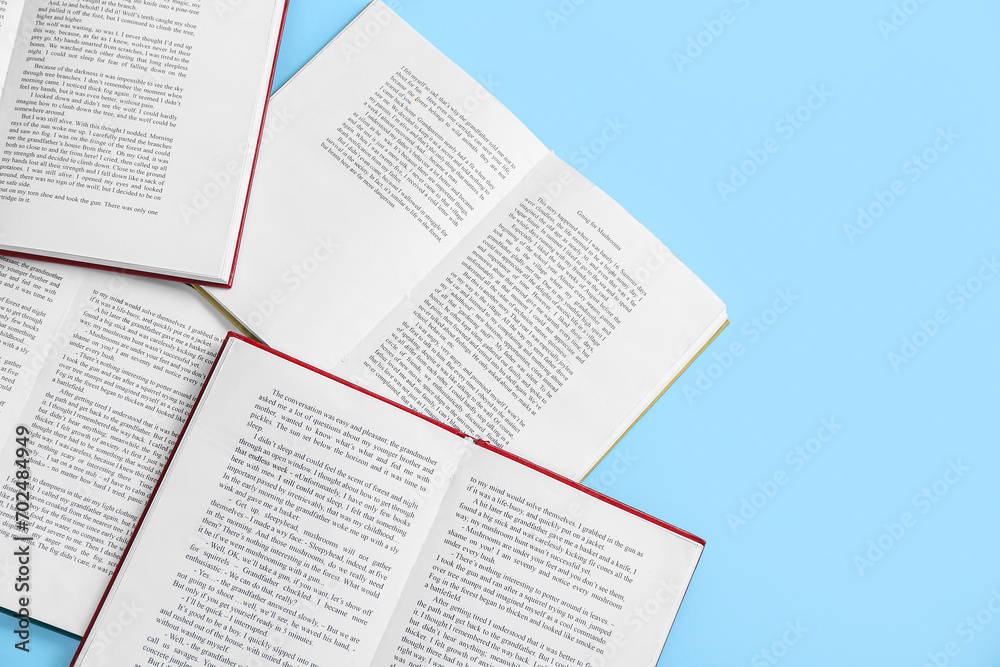 Open books on blue background