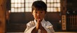 Karate kid showing cuteness by bowing.
