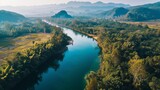 Fototapeta Perspektywa 3d - Beautiful natural scenery of river in southeast Asia tropical green forest with mountains in background, aerial view drone shot