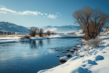 Aufkleber - A picturesque scene of a river flowing through a field covered in snow. Perfect for winter landscapes and nature themes